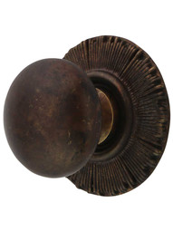 Smooth Cabinet Knob with Sunburst Back Plate - 1 1/4 inch Diameter in Highlighted Bronze.